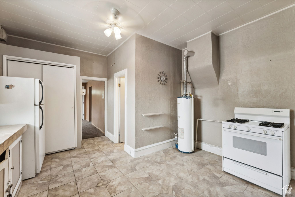 Kitchen with white cabinetry, ceiling fan, white appliances, water heater, and light tile patterned floors
