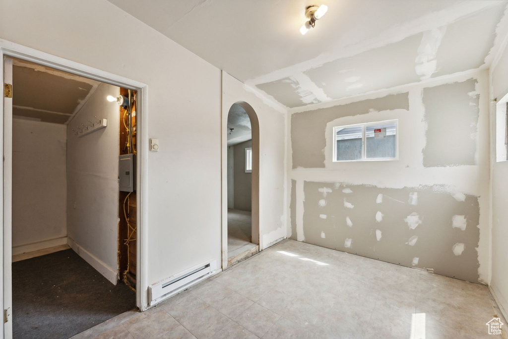 Bathroom with a baseboard radiator and tile patterned floors