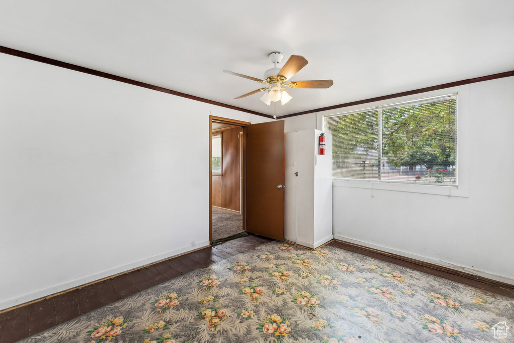 Unfurnished room featuring ceiling fan, hardwood / wood-style floors, and crown molding