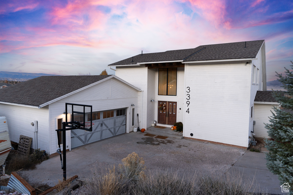 View of front facade featuring a garage