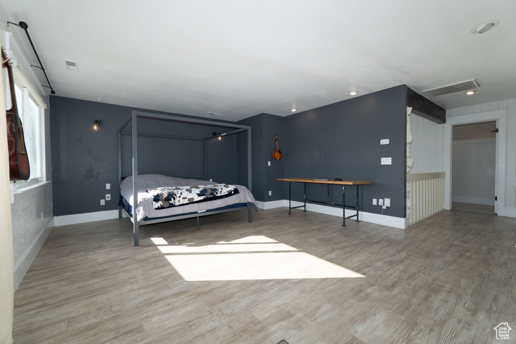 Bedroom with light hardwood / wood-style flooring