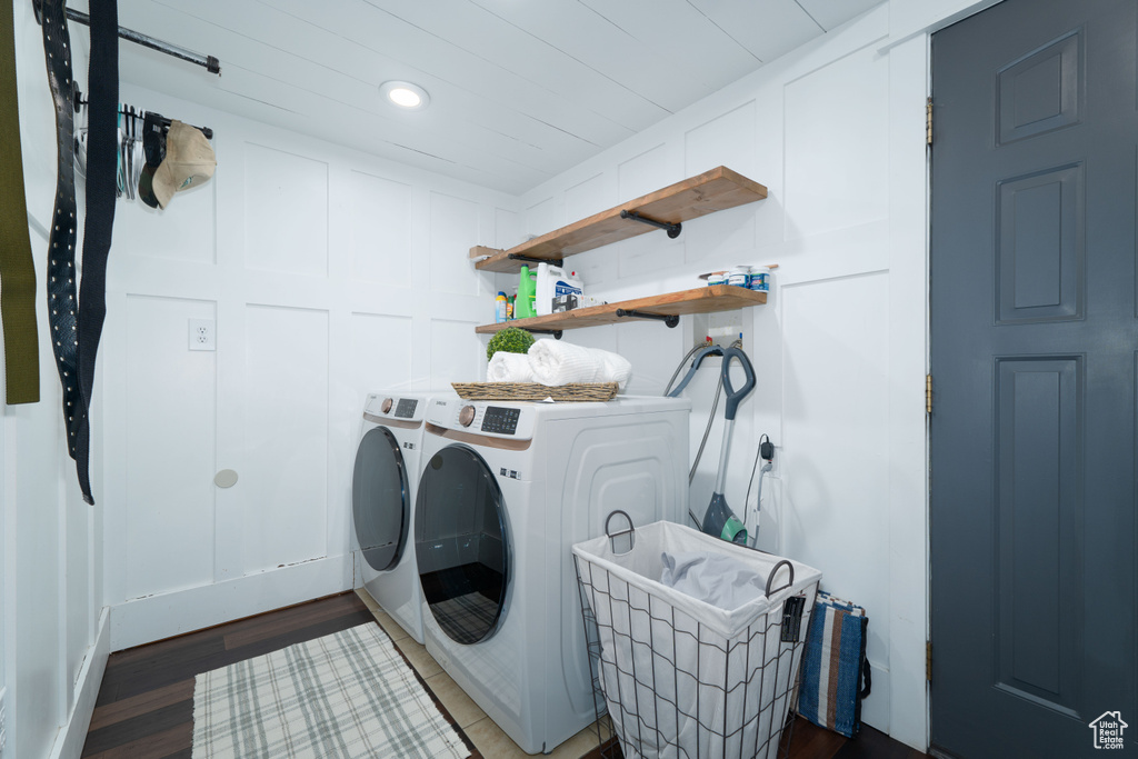 Laundry area with washing machine and dryer and dark wood-type flooring