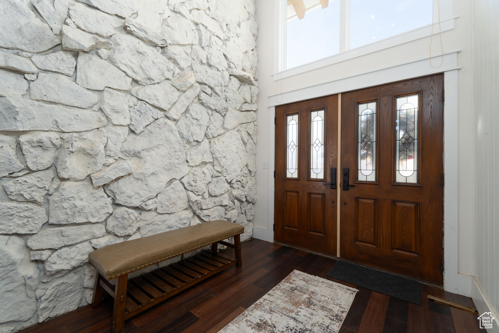 Entrance foyer featuring a high ceiling and dark hardwood / wood-style flooring