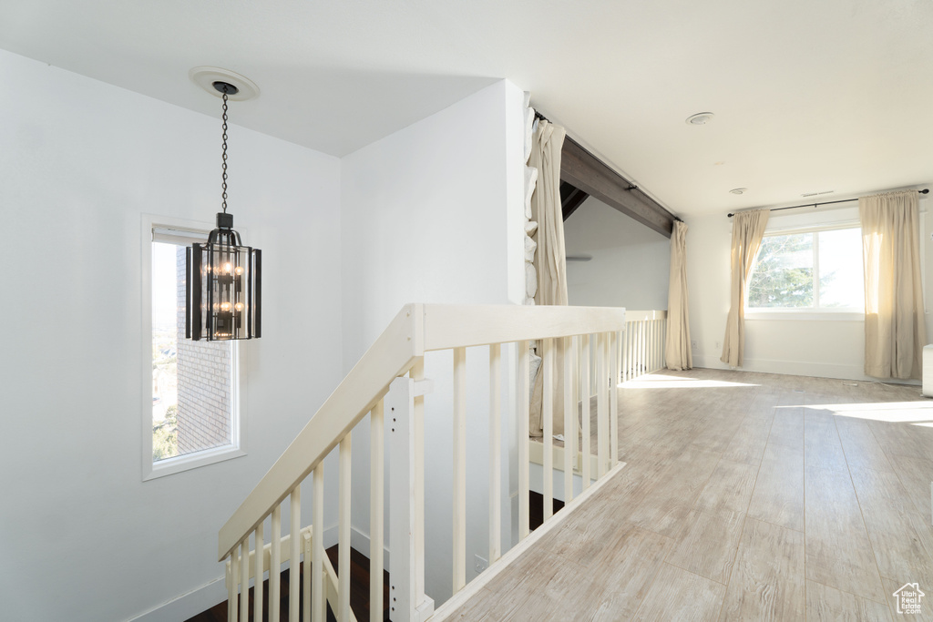 Hall featuring a chandelier and hardwood / wood-style flooring