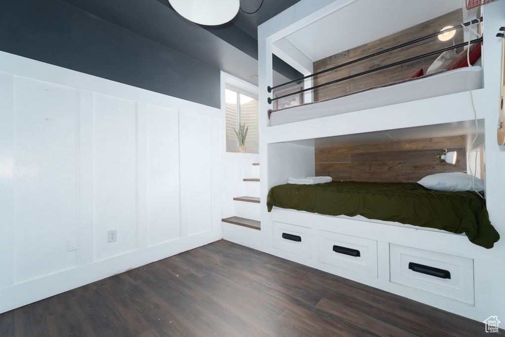 Unfurnished bedroom with dark hardwood / wood-style flooring