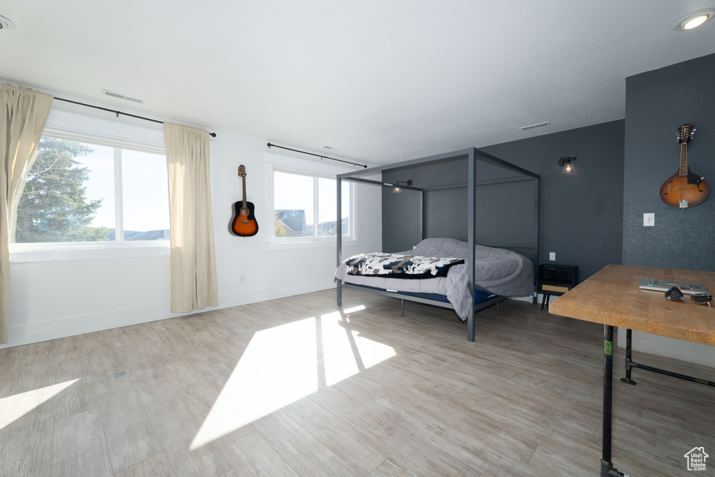 Bedroom with light hardwood / wood-style flooring