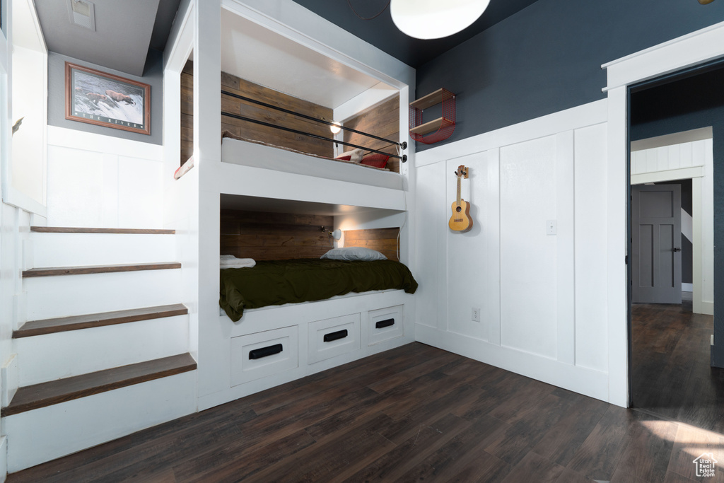 Unfurnished bedroom with dark hardwood / wood-style flooring