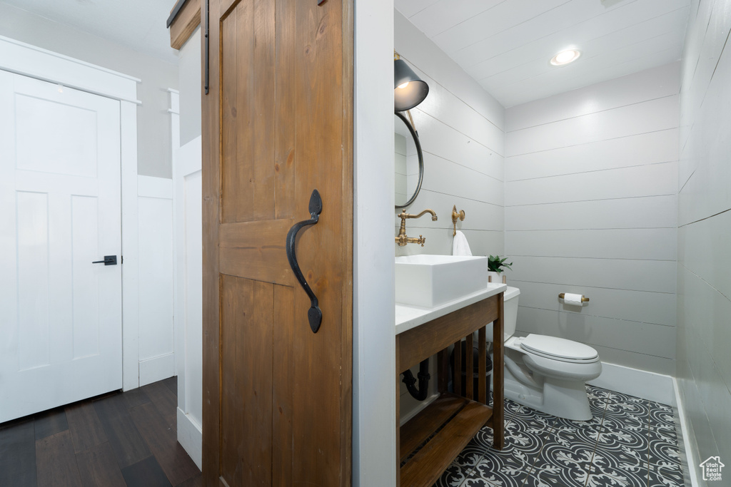 Bathroom with hardwood / wood-style floors, vanity, and toilet