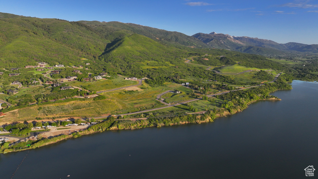 Aerial view of property's location featuring a water and mountain view