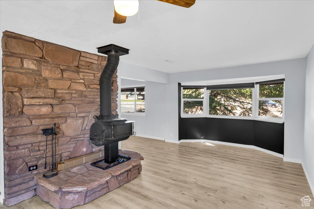 Living room with light wood-type flooring and ceiling fan