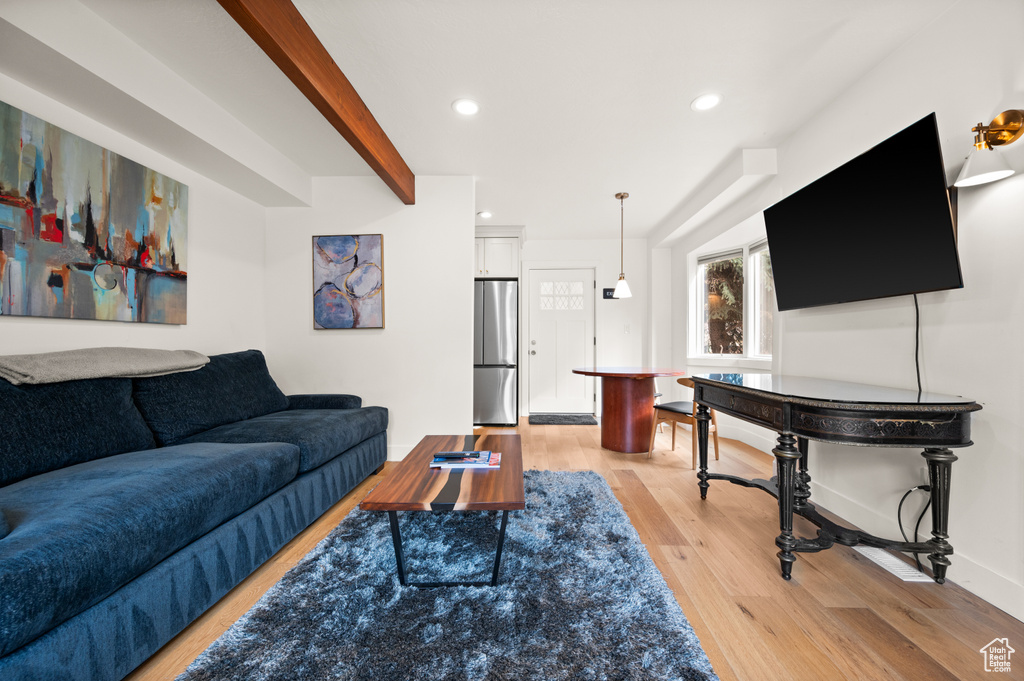 Living room featuring beam ceiling and light hardwood / wood-style floors