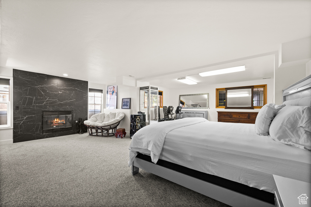 Carpeted bedroom featuring a high end fireplace