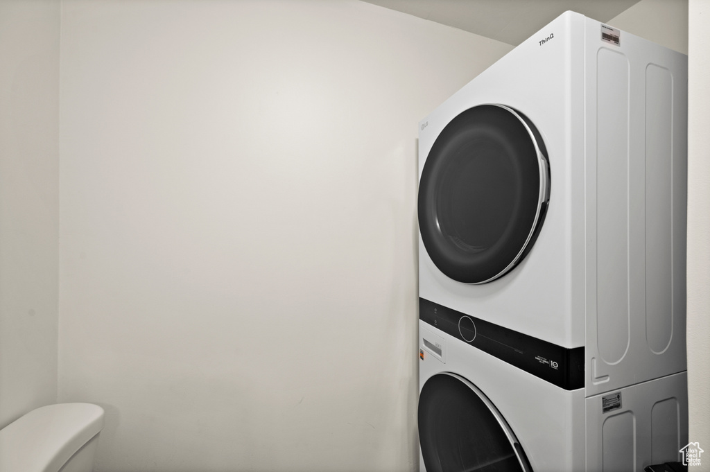 Laundry room featuring stacked washer / drying machine