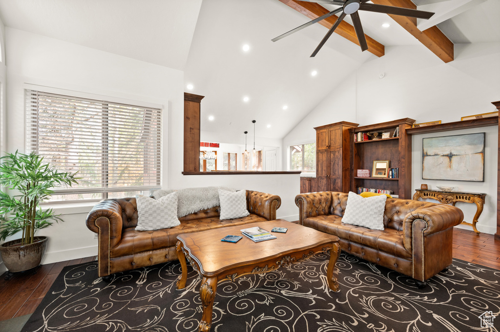 Living room with beam ceiling, ceiling fan, high vaulted ceiling, and dark hardwood / wood-style floors