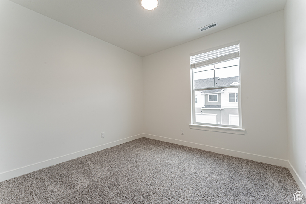 Unfurnished room featuring baseboards and carpet flooring