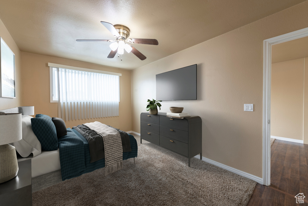 Bedroom with ceiling fan and dark hardwood / wood-style floors