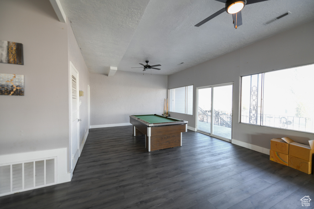 Recreation room featuring a textured ceiling, ceiling fan, dark wood-type flooring, and pool table