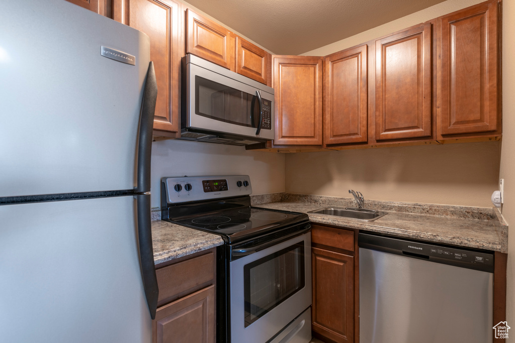 Kitchen with sink and appliances with stainless steel finishes