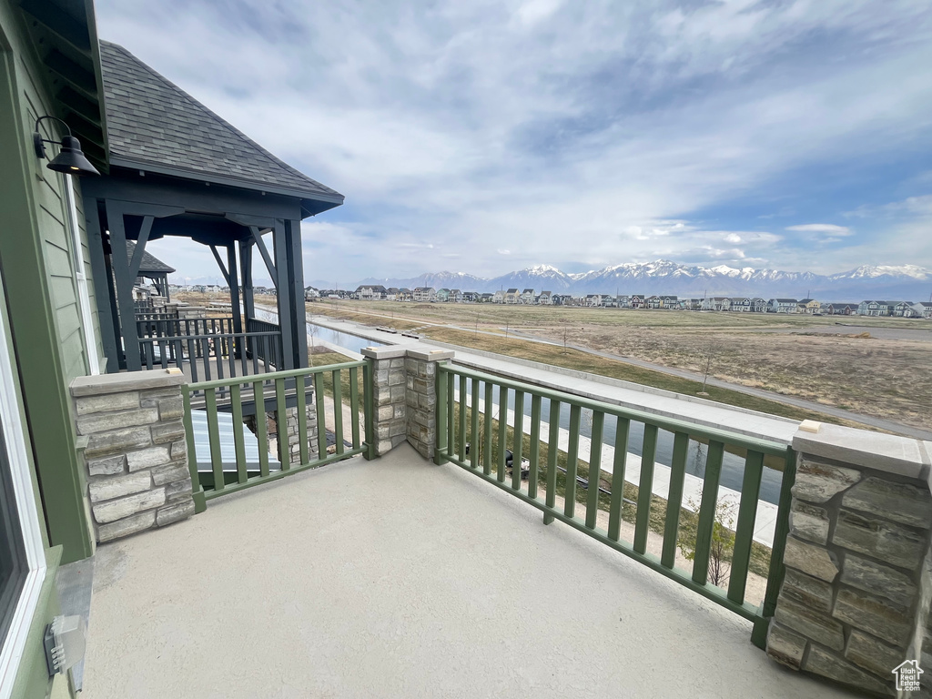 Balcony featuring a water and mountain view