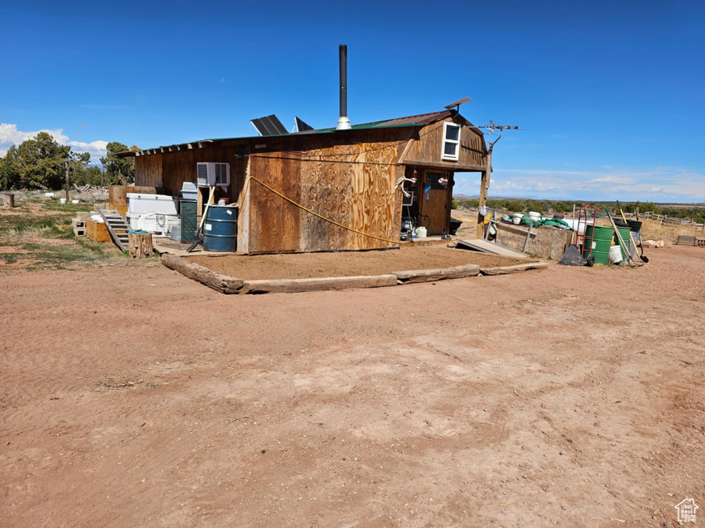 View of property exterior featuring an outdoor structure