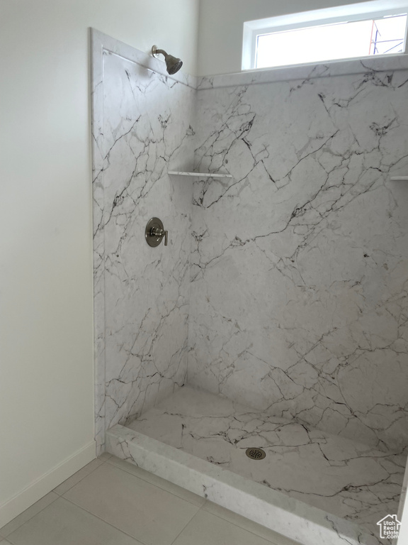 Bathroom featuring a marble finish shower