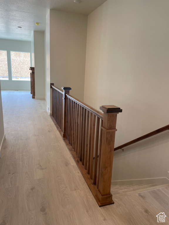 Stairs featuring wood finished floors and baseboards