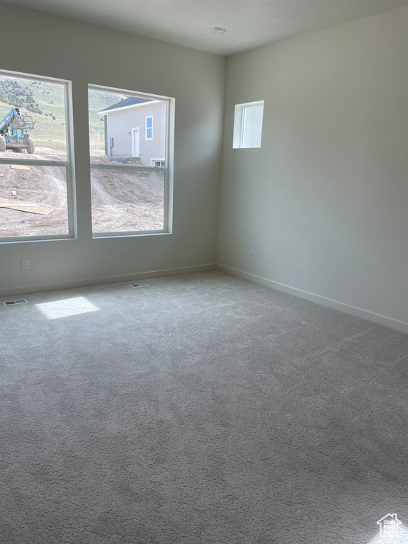Empty room with baseboards and carpet flooring