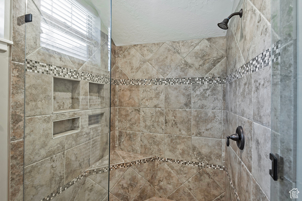 Bathroom with a shower with shower door