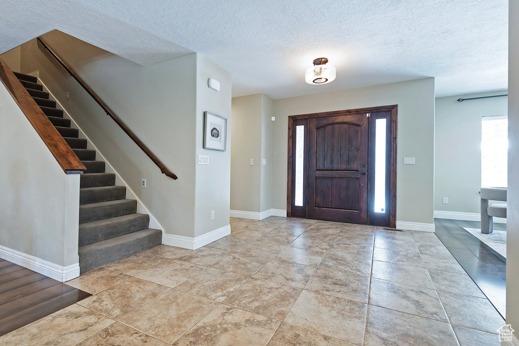 Foyer with a textured ceiling