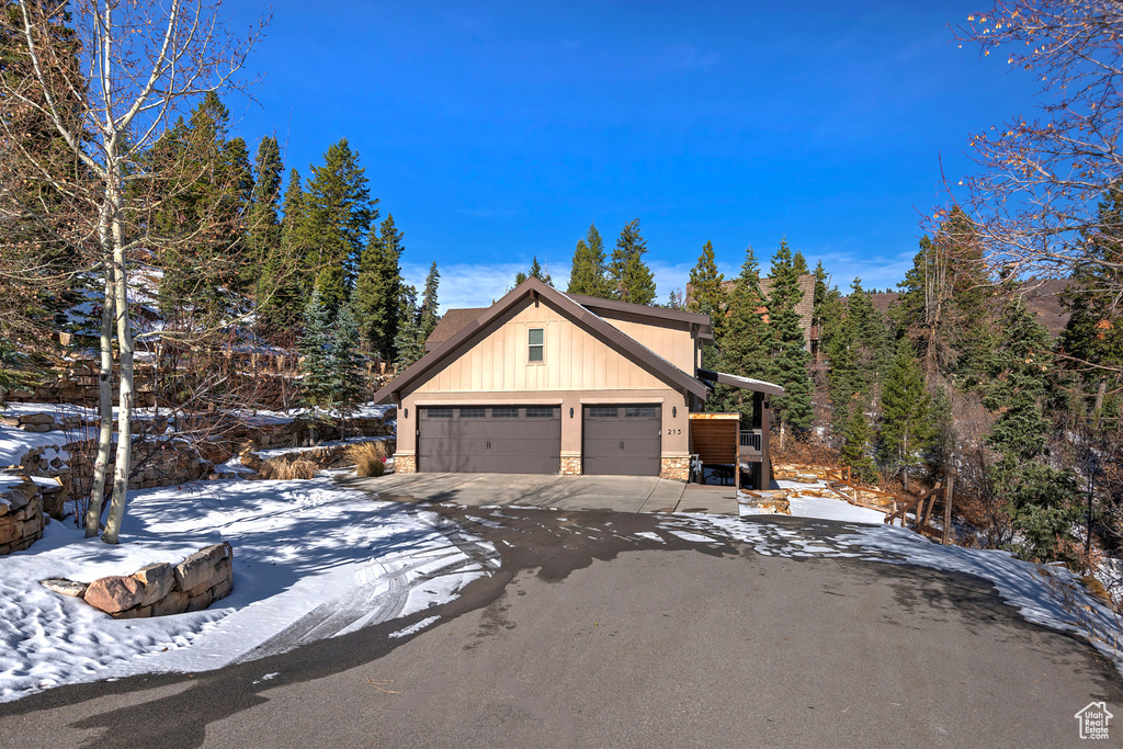 View of snow covered exterior with a garage