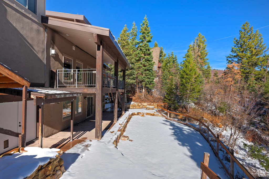 Snowy yard with a balcony