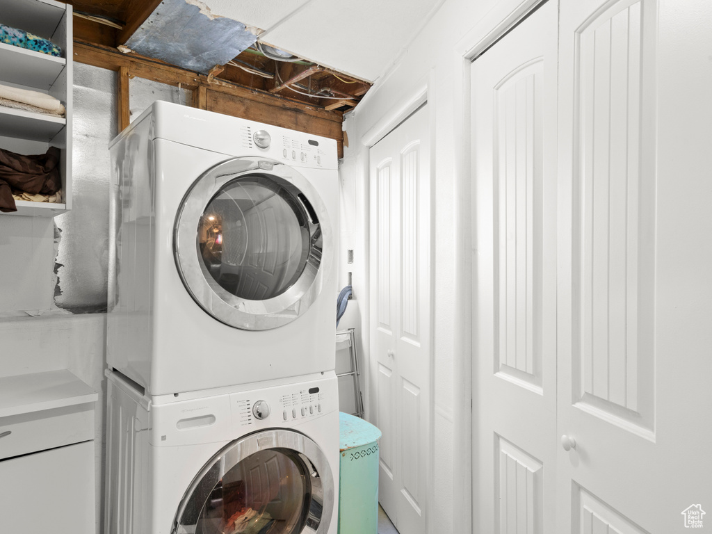 Laundry area featuring stacked washer / drying machine