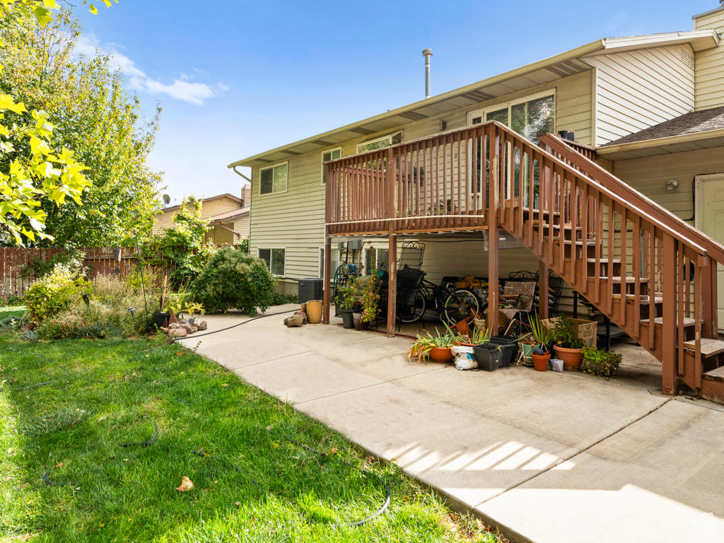 Back of property with a yard and a patio area