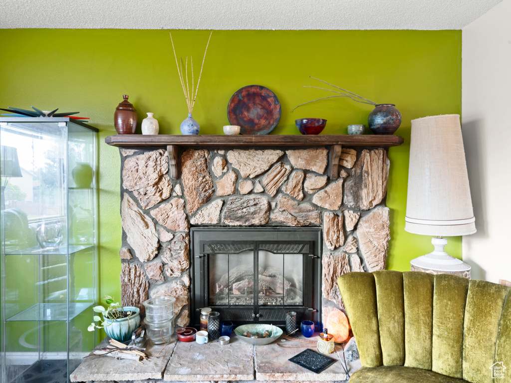 Interior details with a fireplace and a textured ceiling