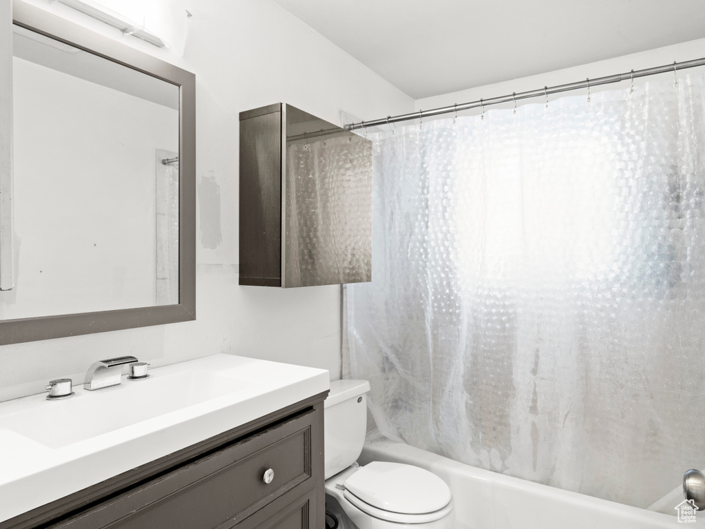 Full bathroom with vanity, toilet, and shower / tub combo