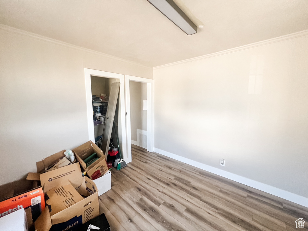 Unfurnished room featuring ornamental molding and light wood finished floors