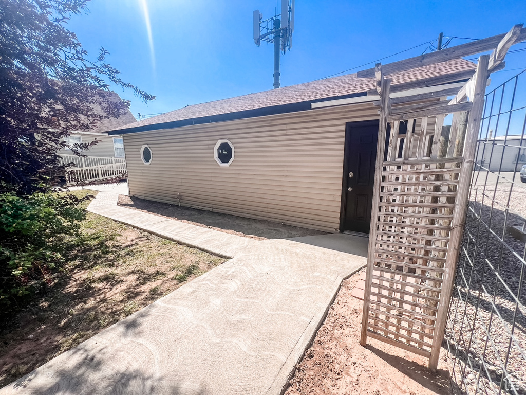 Rear view of property with a shingled roof
