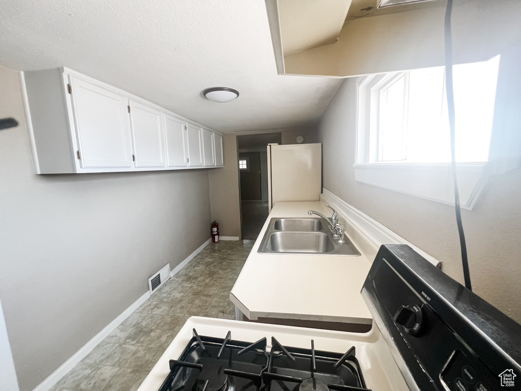 Washroom featuring a sink and baseboards