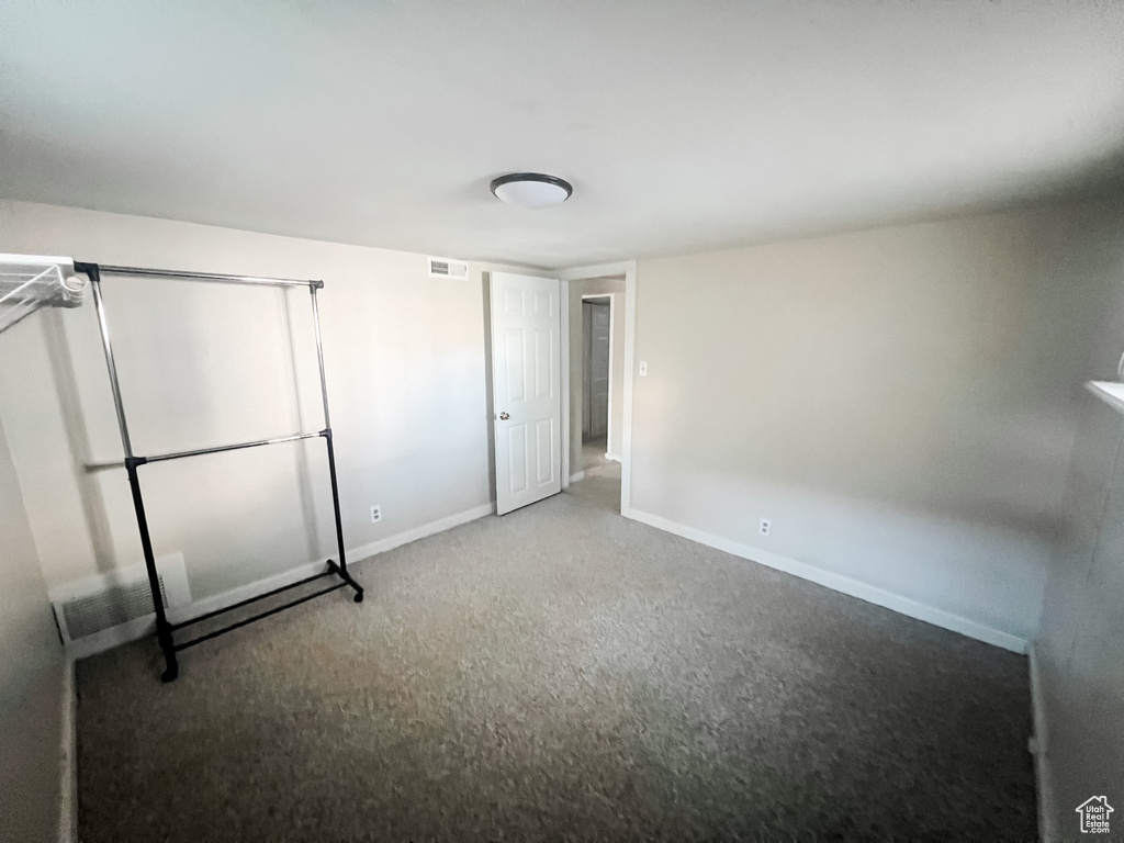 Unfurnished bedroom featuring carpet floors and baseboards