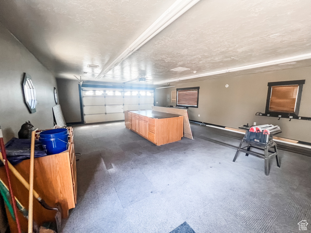 Garage featuring baseboards