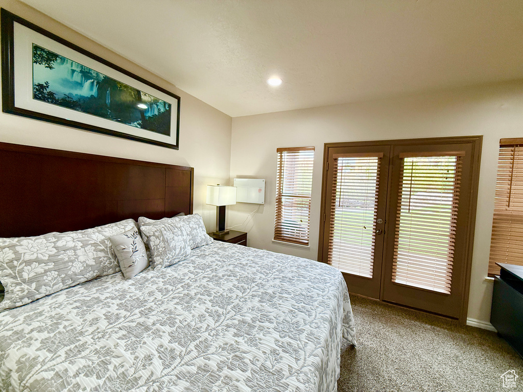 Bedroom featuring access to outside, light colored carpet, baseboards, and recessed lighting