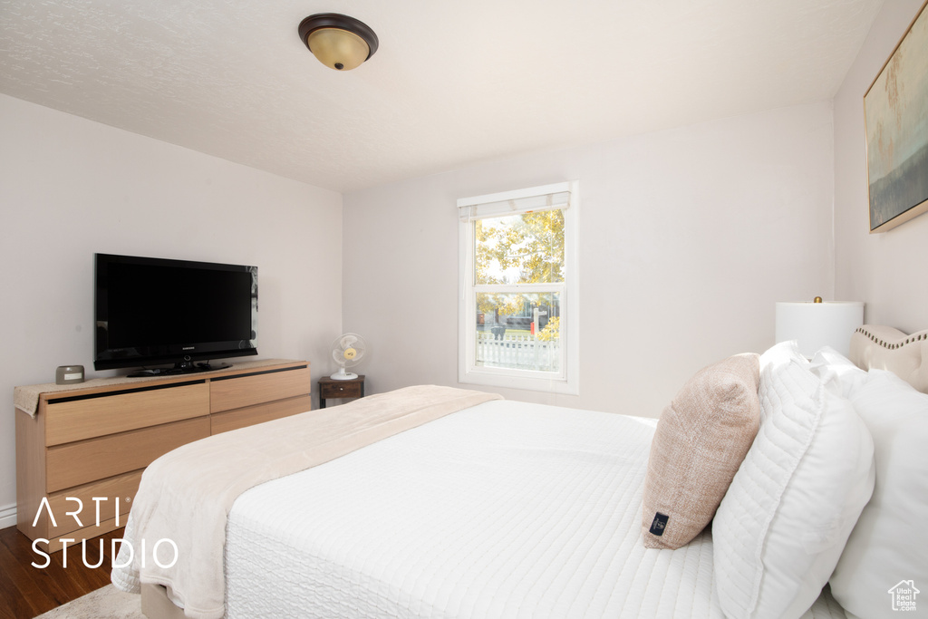 Bedroom with hardwood / wood-style floors