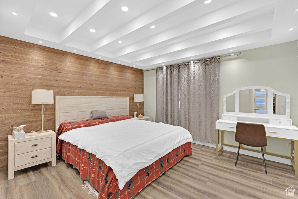 Bedroom with wood-type flooring and wooden walls