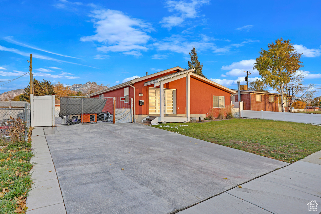 Exterior space with a front yard and a mountain view