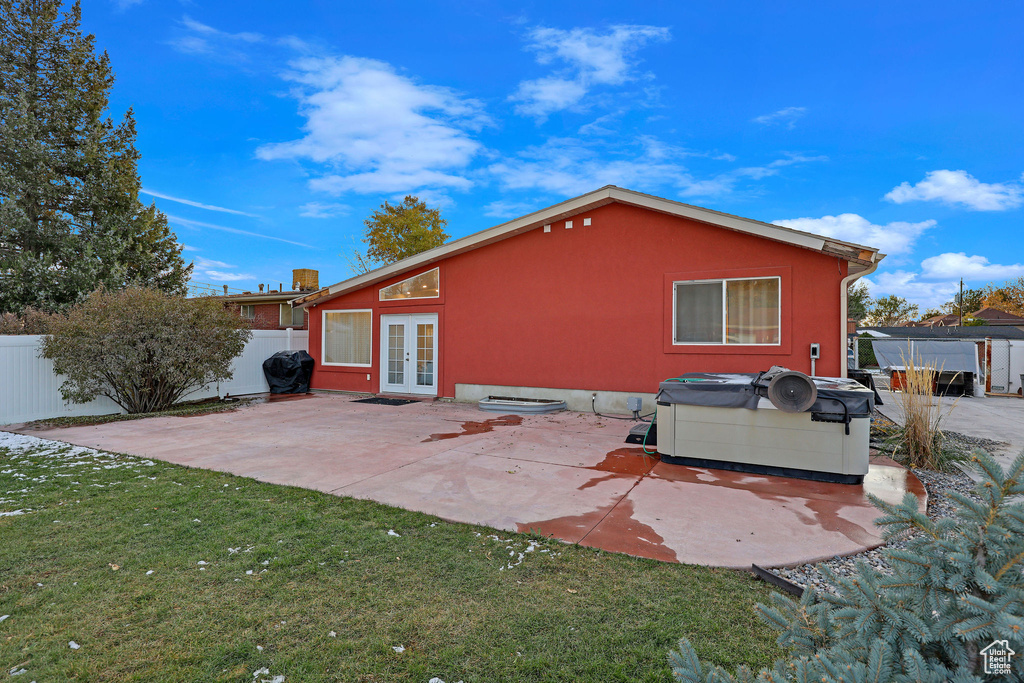 Rear view of property featuring french doors, a yard, and a patio area