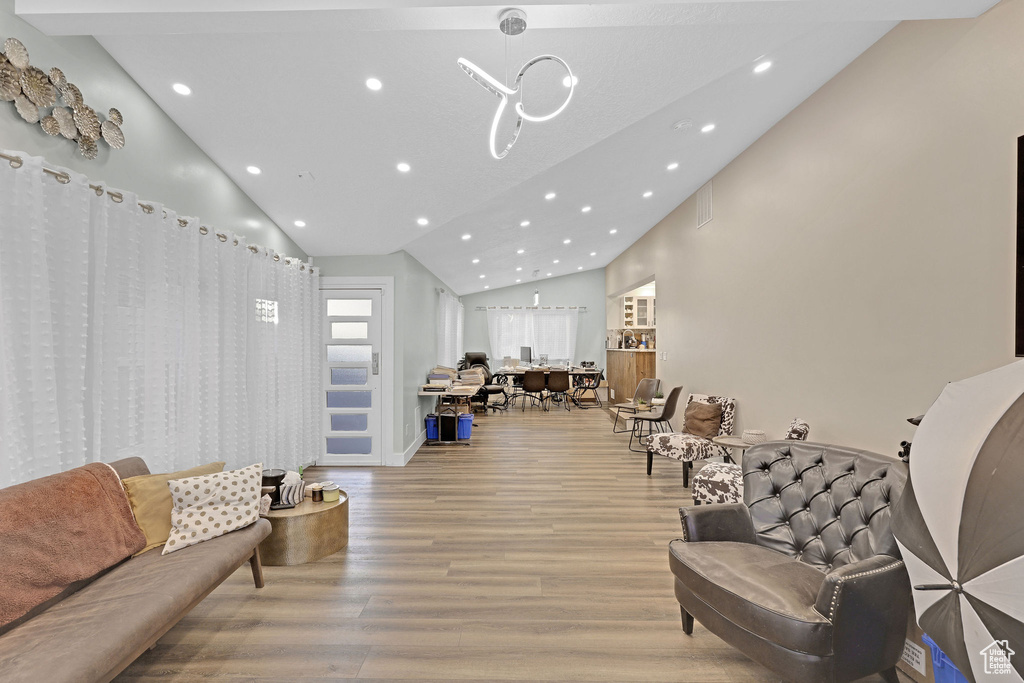 Living room featuring high vaulted ceiling and light wood-type flooring