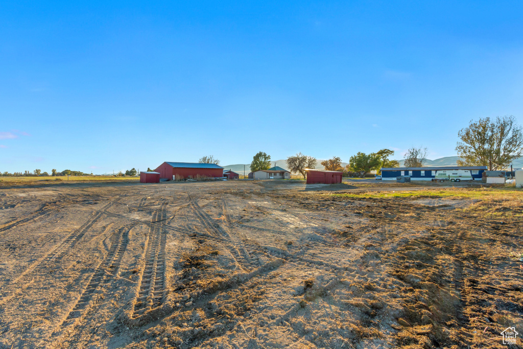 View of yard with a rural view and an outdoor structure