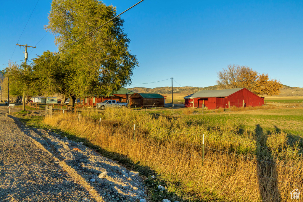 View of yard with an outbuilding and a rural view