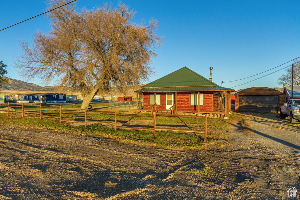 View of front of home with an outbuilding and a garage