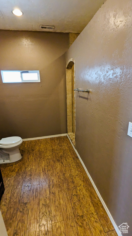 Bathroom with toilet and wood-type flooring